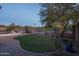 Landscaped backyard with artificial turf and a tree at 5037 E Sleepy Ranch Rd, Cave Creek, AZ 85331