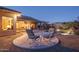Evening view of a patio with seating near the pool at 5037 E Sleepy Ranch Rd, Cave Creek, AZ 85331