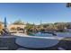 Inviting kidney-shaped pool with waterfall feature and lounge chairs at 5037 E Sleepy Ranch Rd, Cave Creek, AZ 85331