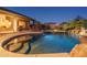 Inviting pool with a waterfall at dusk at 5037 E Sleepy Ranch Rd, Cave Creek, AZ 85331