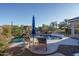 Relaxing pool area with patio furniture and blue umbrella at 5037 E Sleepy Ranch Rd, Cave Creek, AZ 85331