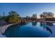 Stunning pool and waterfall at sunset at 5037 E Sleepy Ranch Rd, Cave Creek, AZ 85331