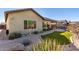 Landscaped backyard with artificial turf and paved pathway at 5640 W Victory Way, Florence, AZ 85132
