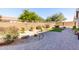 Landscaped backyard with artificial turf and paved patio at 5640 W Victory Way, Florence, AZ 85132