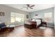 Spacious bedroom with ceiling fan, wood flooring and large windows at 5640 W Victory Way, Florence, AZ 85132