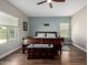 Bright bedroom with wood flooring and a sleigh bed at 5640 W Victory Way, Florence, AZ 85132