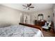 Main bedroom with wood flooring, ceiling fan, and access to bathroom at 5640 W Victory Way, Florence, AZ 85132
