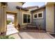 Courtyard with wrought iron gate, stone pathway, and seating area at 5640 W Victory Way, Florence, AZ 85132