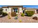 One-story home with desert landscaping and a two-car garage at 5640 W Victory Way, Florence, AZ 85132