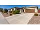 House exterior with a long driveway and desert landscaping at 5640 W Victory Way, Florence, AZ 85132