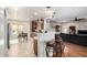 Open kitchen with island, breakfast bar, stainless steel appliances, and ample cabinet space at 5640 W Victory Way, Florence, AZ 85132