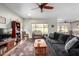 Living room with dark gray couch and ceiling fan at 5640 W Victory Way, Florence, AZ 85132