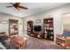 Living room with hardwood floors, ceiling fan, and built-in shelving at 5640 W Victory Way, Florence, AZ 85132
