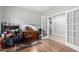 Bright home office features wood flooring, french doors and built-in shelving at 5640 W Victory Way, Florence, AZ 85132