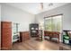 Home office with built-in shelving, wood flooring, and plenty of natural light at 5640 W Victory Way, Florence, AZ 85132
