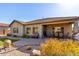 Relaxing patio area with seating and views of the backyard at 5640 W Victory Way, Florence, AZ 85132