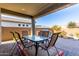 Covered patio with table and chairs at 5640 W Victory Way, Florence, AZ 85132