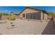 Spacious backyard with gravel, cacti, and a screened patio at 6416 E Hacienda La Noria Ln, Gold Canyon, AZ 85118