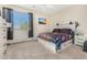 Bedroom with large bed, dresser, and access to patio at 6416 E Hacienda La Noria Ln, Gold Canyon, AZ 85118