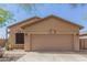 Tan house with a two-car garage and desert landscaping at 6416 E Hacienda La Noria Ln, Gold Canyon, AZ 85118