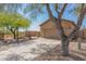 Tan house with a two-car garage and desert landscaping at 6416 E Hacienda La Noria Ln, Gold Canyon, AZ 85118