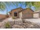 Tan house with a two-car garage and desert landscaping at 6416 E Hacienda La Noria Ln, Gold Canyon, AZ 85118