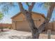 Tan house with a two-car garage and desert landscaping at 6416 E Hacienda La Noria Ln, Gold Canyon, AZ 85118