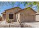 Tan house with a two-car garage and desert landscaping at 6416 E Hacienda La Noria Ln, Gold Canyon, AZ 85118