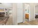 Hallway with linen closet, bathroom access, and view into living room at 6416 E Hacienda La Noria Ln, Gold Canyon, AZ 85118