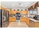 Open kitchen boasts stainless steel appliances and wood cabinets at 6416 E Hacienda La Noria Ln, Gold Canyon, AZ 85118