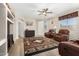 Spacious living room featuring a southwestern rug, leather recliners, and built-in shelving at 6416 E Hacienda La Noria Ln, Gold Canyon, AZ 85118