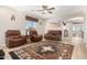 Bright living room with comfortable leather seating and a large artwork piece above the couch at 6416 E Hacienda La Noria Ln, Gold Canyon, AZ 85118