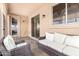Covered patio with wicker seating and access to the backyard at 6416 E Hacienda La Noria Ln, Gold Canyon, AZ 85118