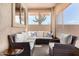 Bright sunroom with wicker furniture and desert landscape views at 6416 E Hacienda La Noria Ln, Gold Canyon, AZ 85118