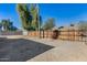Backyard view with gravel, trees, and fence at 6934 W Mclellan Rd, Glendale, AZ 85303