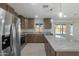 Spacious kitchen with island, stainless steel appliances, and granite counters at 6934 W Mclellan Rd, Glendale, AZ 85303