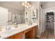 Elegant bathroom with double sinks, a shower, and a walk-in closet at 731 E Las Colinas Pl, Chandler, AZ 85249