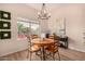 Bright dining room featuring a round wooden table with four chairs and a large window at 731 E Las Colinas Pl, Chandler, AZ 85249