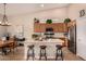 Modern kitchen with light wood cabinets, stainless steel appliances and an island with seating at 731 E Las Colinas Pl, Chandler, AZ 85249