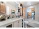 Bright bathroom with vanity, decorative mirrors, and a tiled shower/tub combo at 7807 N 17Th Dr, Phoenix, AZ 85021