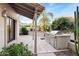 Outdoor patio with built-in grill and covered seating area at 8462 N 84Th Pl, Scottsdale, AZ 85258