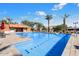 Inviting community pool with lounge chairs and palm trees at 8865 E Baseline Rd # 1106, Mesa, AZ 85209