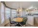 Dining area with round table and four chairs near the kitchen at 8865 E Baseline Rd # 1106, Mesa, AZ 85209