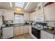 Kitchen with skylights, white cabinets, and a spacious layout at 8865 E Baseline Rd # 1106, Mesa, AZ 85209