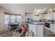 Kitchen with island and seating area, open to the adjacent living room at 8865 E Baseline Rd # 1106, Mesa, AZ 85209