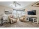 Bright living room featuring two recliner chairs and a fireplace at 8865 E Baseline Rd # 1106, Mesa, AZ 85209