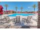 Community pool with lounge chairs and umbrellas at 8865 E Baseline Rd # 1106, Mesa, AZ 85209