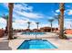 Community pool and spa with lounge chairs and palm trees at 8865 E Baseline Rd # 1106, Mesa, AZ 85209