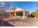 Home featuring a covered patio and low-maintenance desert landscaping in the backyard at 10417 E Champagne Dr, Sun Lakes, AZ 85248