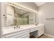 Bright bathroom featuring double sinks, framed mirror, and glass-enclosed shower at 10417 E Champagne Dr, Sun Lakes, AZ 85248